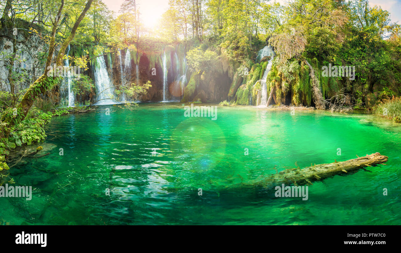 panoramic view of ray of light shining through trees on pond at Plitvice Lakes National Park, Croatia Stock Photo