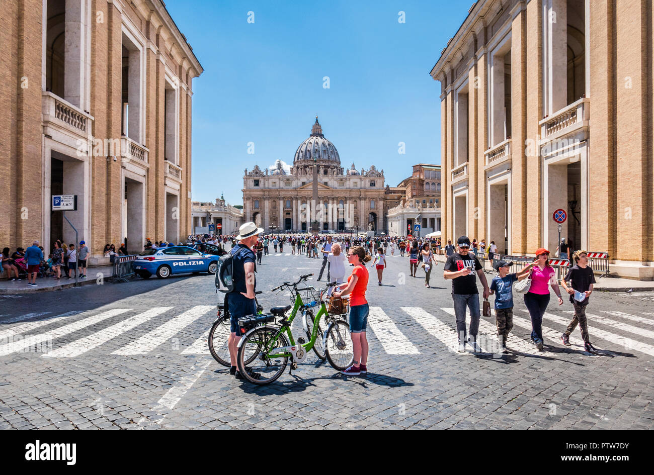 cyclists at Via Conciliazione, Rome, which leads into Vatican City, St. Peter's Square and towards St. Peter's Basilica Stock Photo