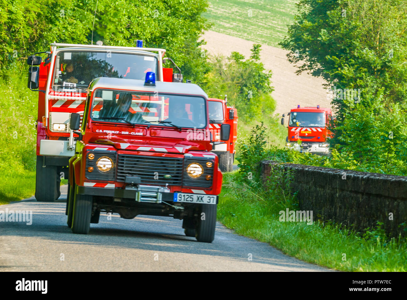 French fire engines on call on country lane. Stock Photo