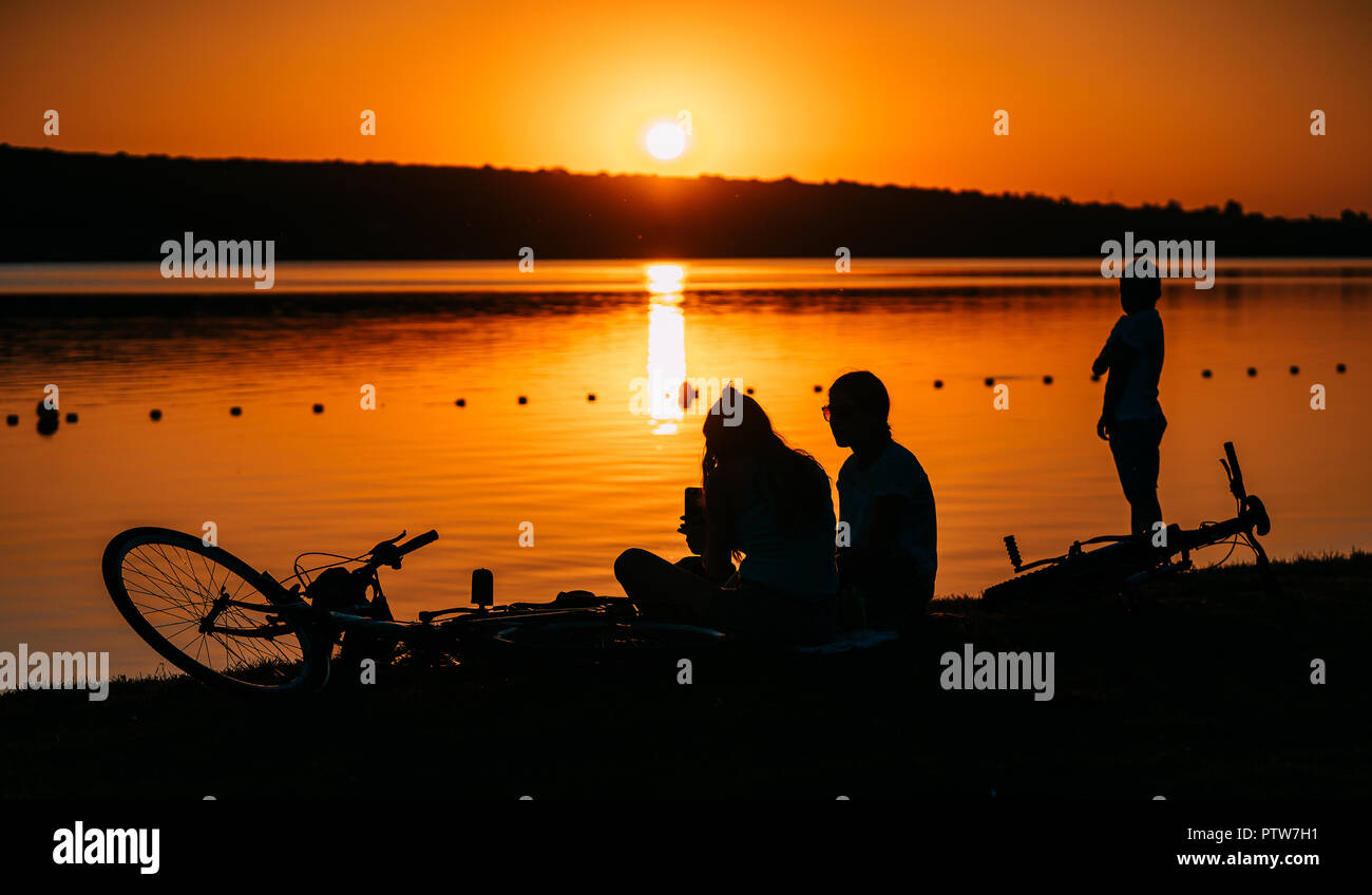 two girls are resting on the river bank Stock Photo - Alamy