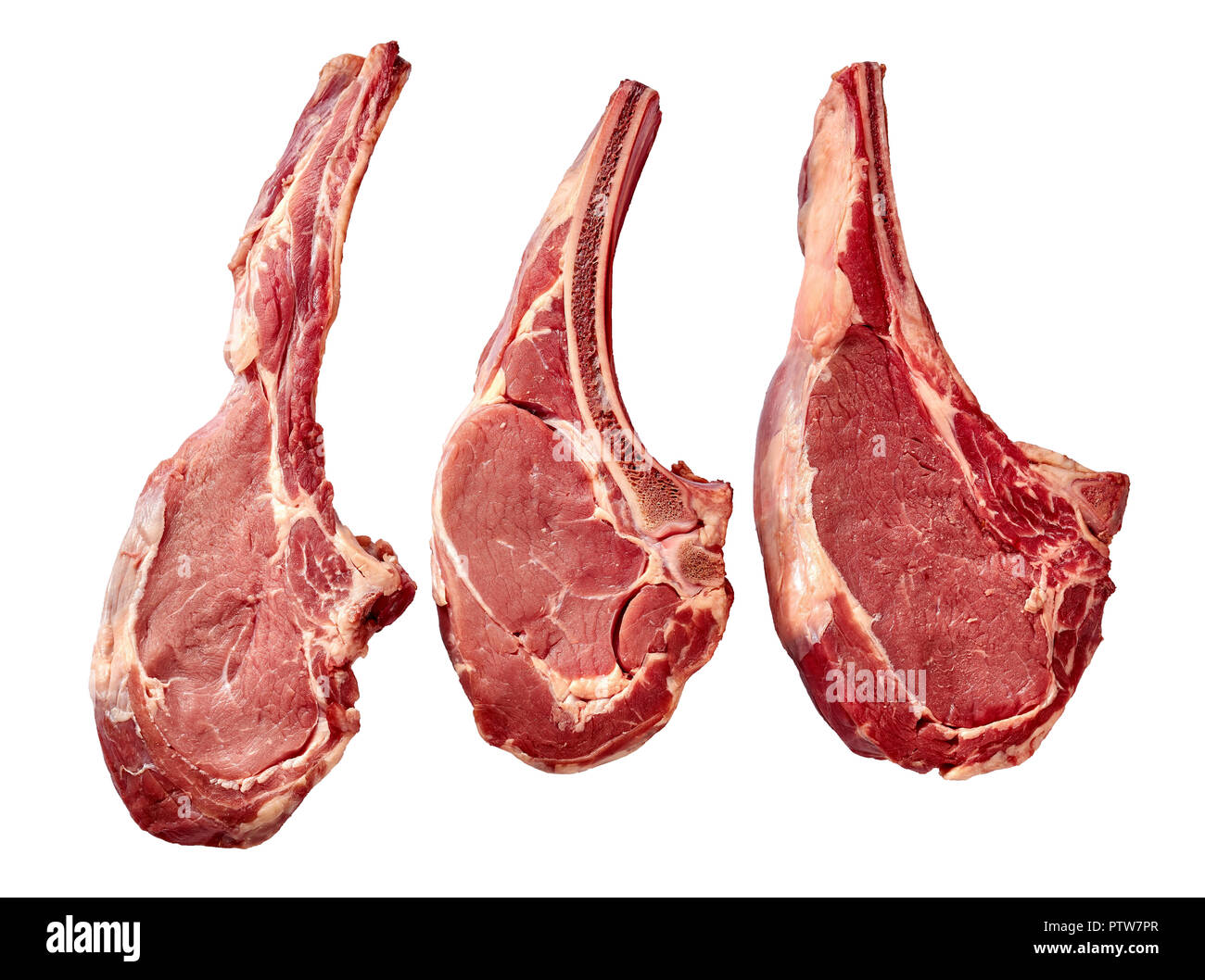 three Dry aged raw tomahawk beef steaks isolated on white background, front view, close-up Stock Photo