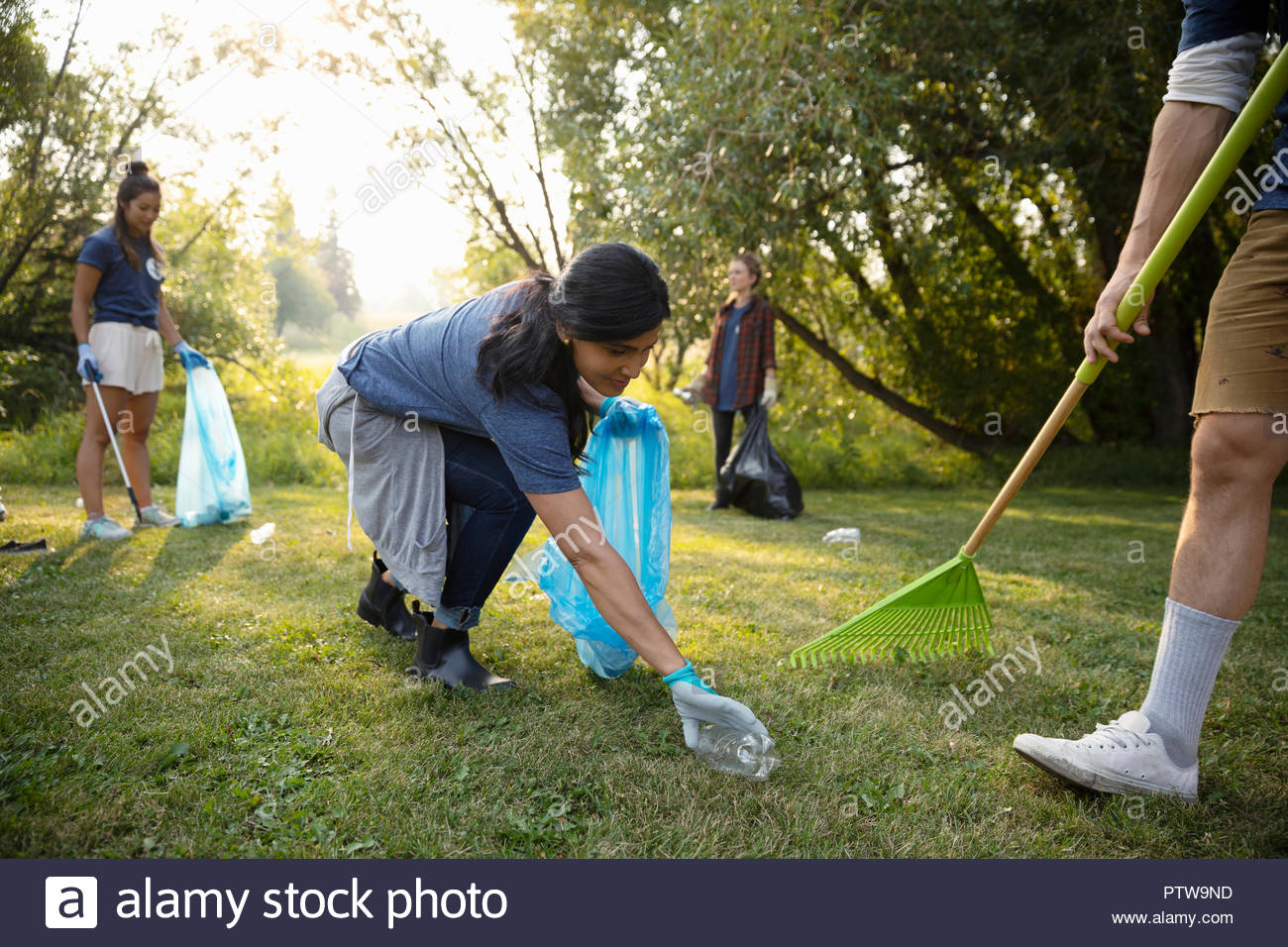 Woman volunteering, cleaning up garbage in park Stock Photo Alamy