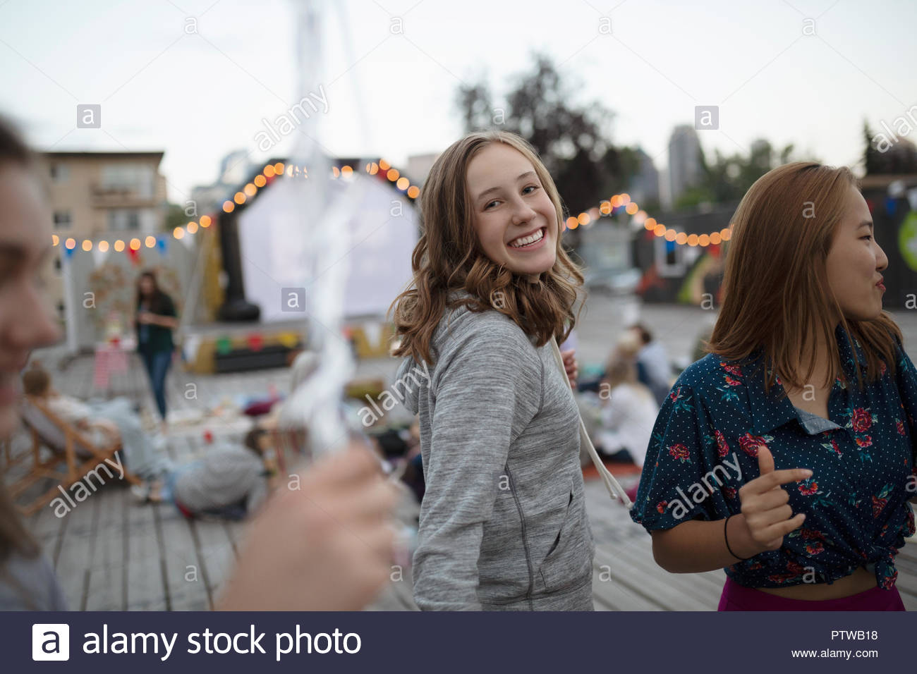 Portrait smiling, confident teenage girl at movie in the park Stock Photo