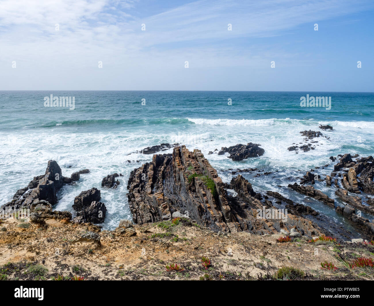 Rocky surf and trail at Praia de Almograve, Alentejo, Vicentine coast