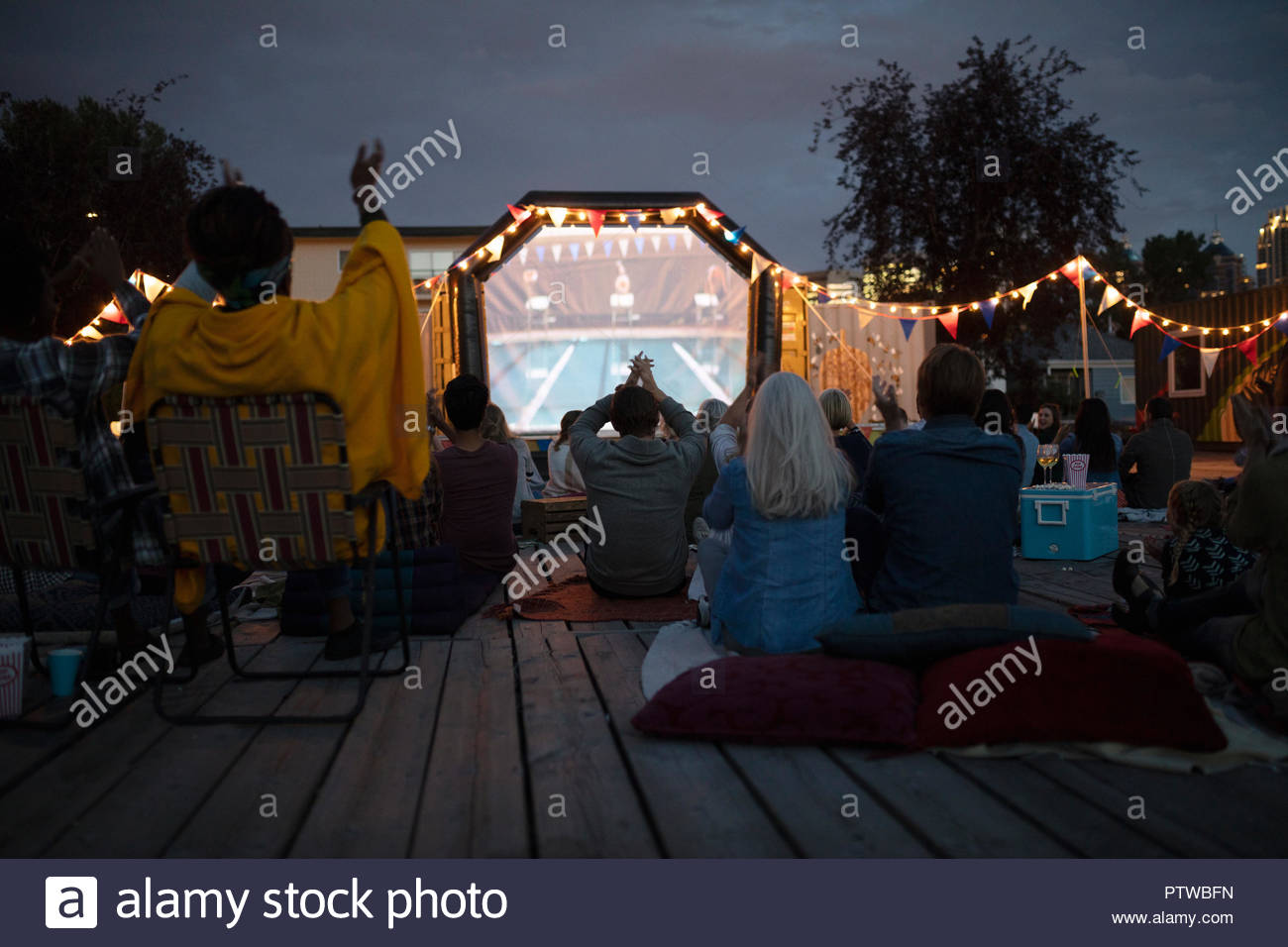 Crowd clapping, watching sports match in the park Stock Photo