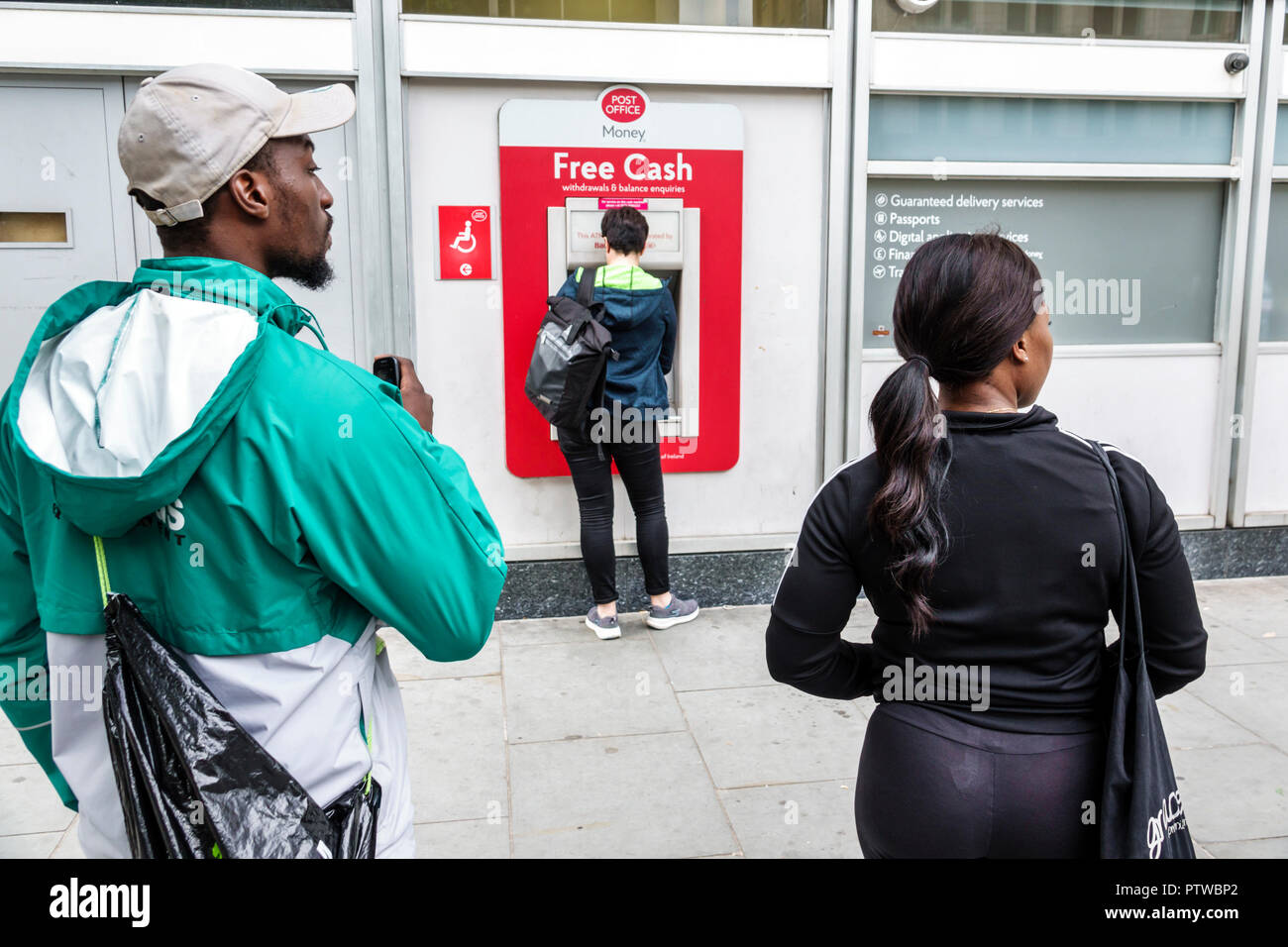 London England,UK,Southwark,Blackfriars Road,Post Office Card Account POCA,ATM,automatic teller,Black man men male,woman female women,couple,UK GB Eng Stock Photo