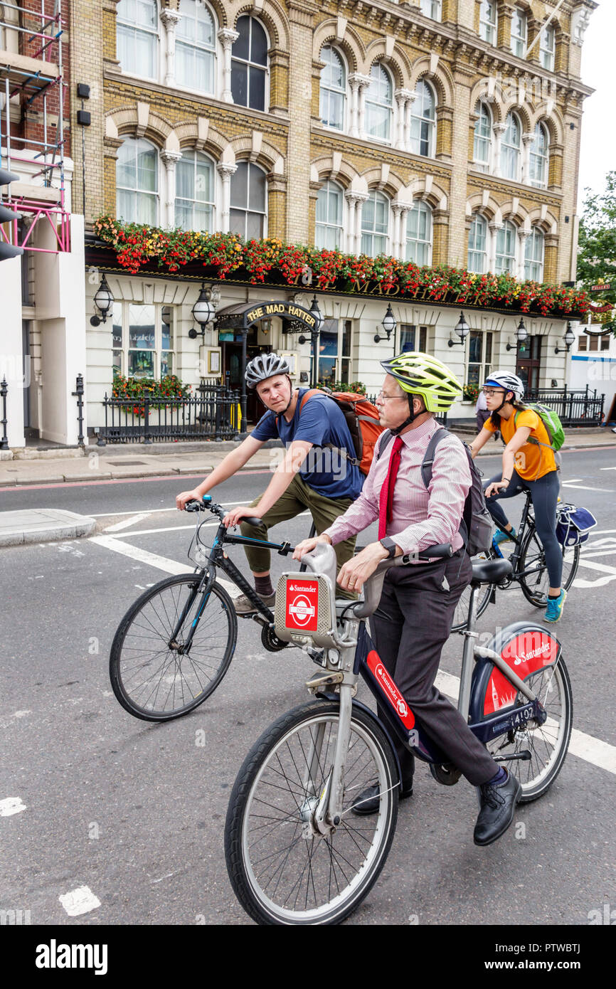 London England,UK,Southwark,street,commuter,riding bicycle,helmet,man men male,Santander bike sharing,green,alternative public transport,friendly,redu Stock Photo