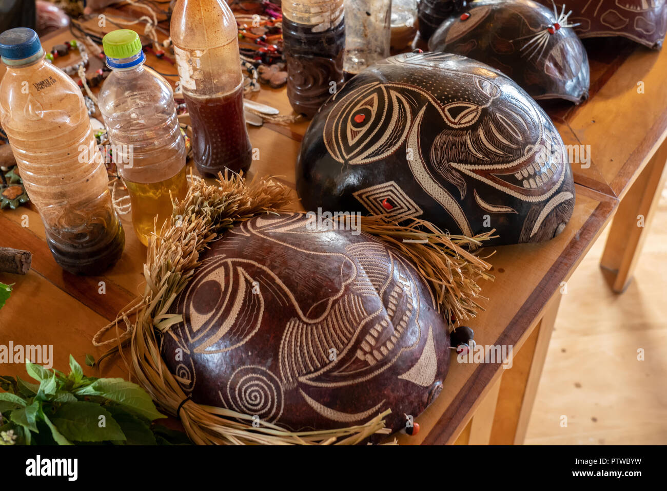 Amazon National Park, Peru, South America.  Handmade Shaman masks and bottles of remedies. Stock Photo