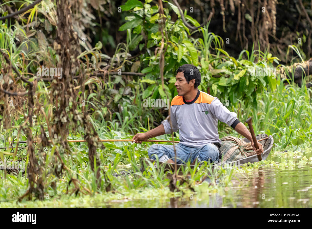 Amazon National Park, Peru, South America. Happy fisherman in a dugout