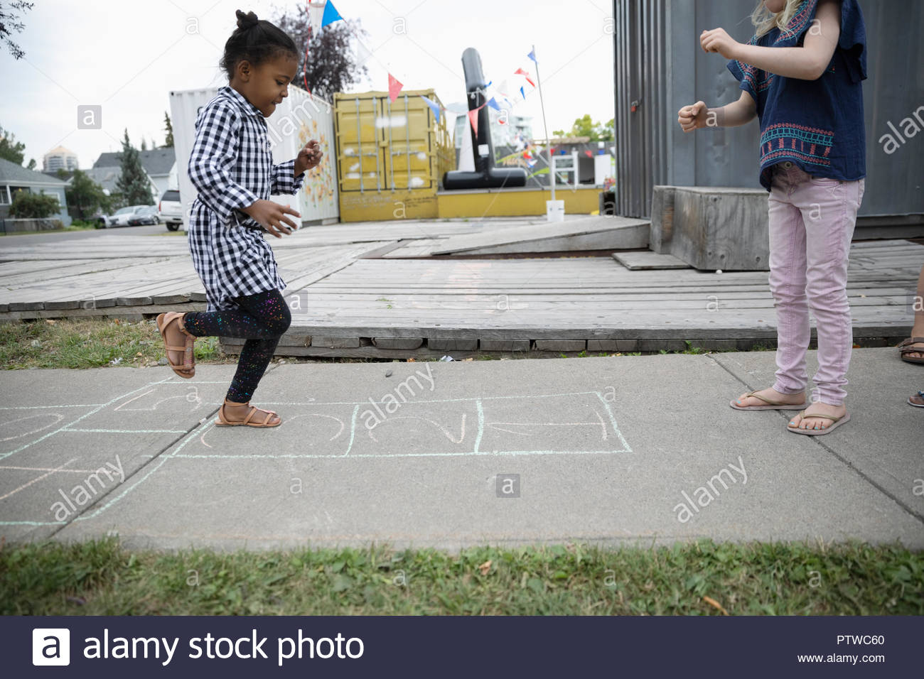 Girl playing hopscotch on sidewalk Stock Photo Alamy