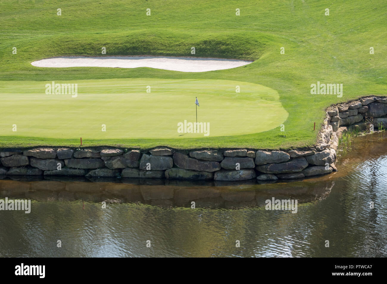 Challenging hole on luxury golf course with water and sand Stock Photo