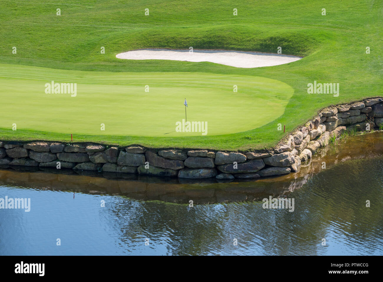 Challenging hole on luxury golf course with water and sand Stock Photo