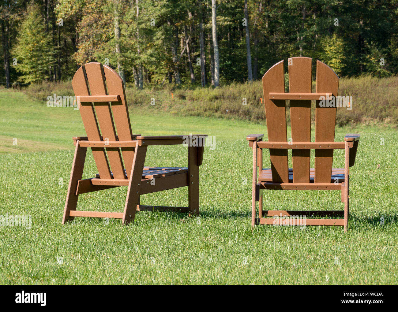 Rear View Of Two Wooden Painted Adirondack Chairs Stock Photo