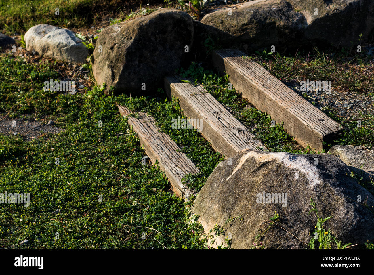 Park wooden stairs with grass and rocks by pressure treated lumber Stock Photo
