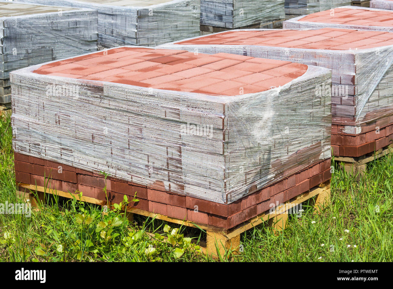 Red paving slab on pallets, red paving brick Stock Photo