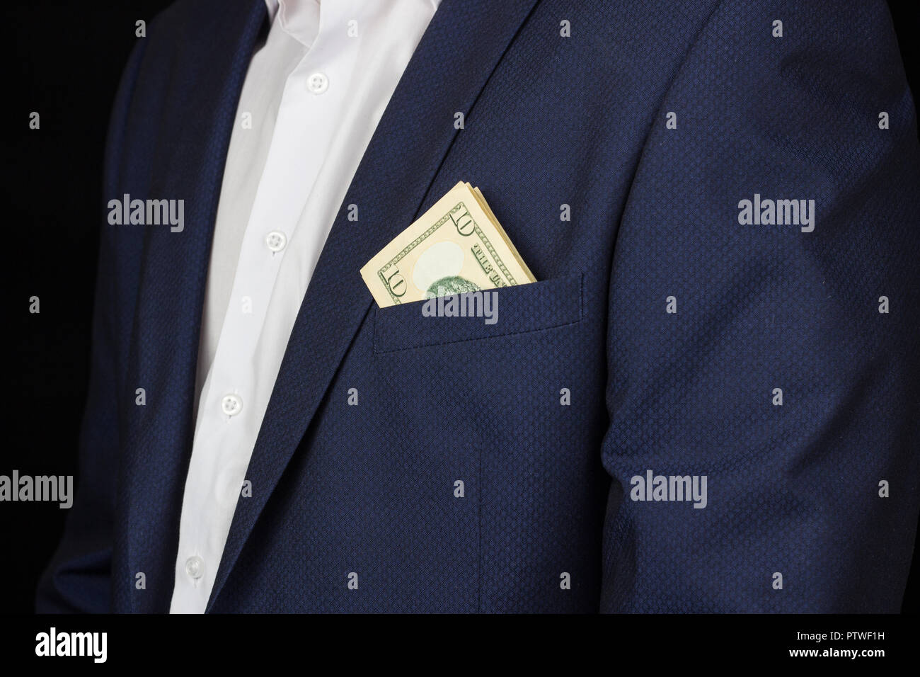 A man in a suit with a pocket is seen money dollars, ten dollars, studio, handsome Stock Photo