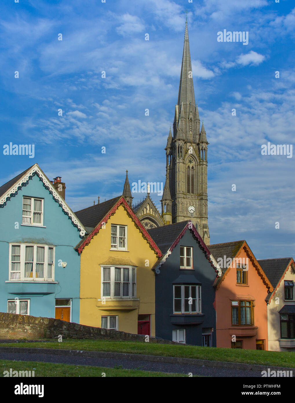 Facades at West View with St. Colmans Cathedral in the background, Cobh, Ireland Stock Photo