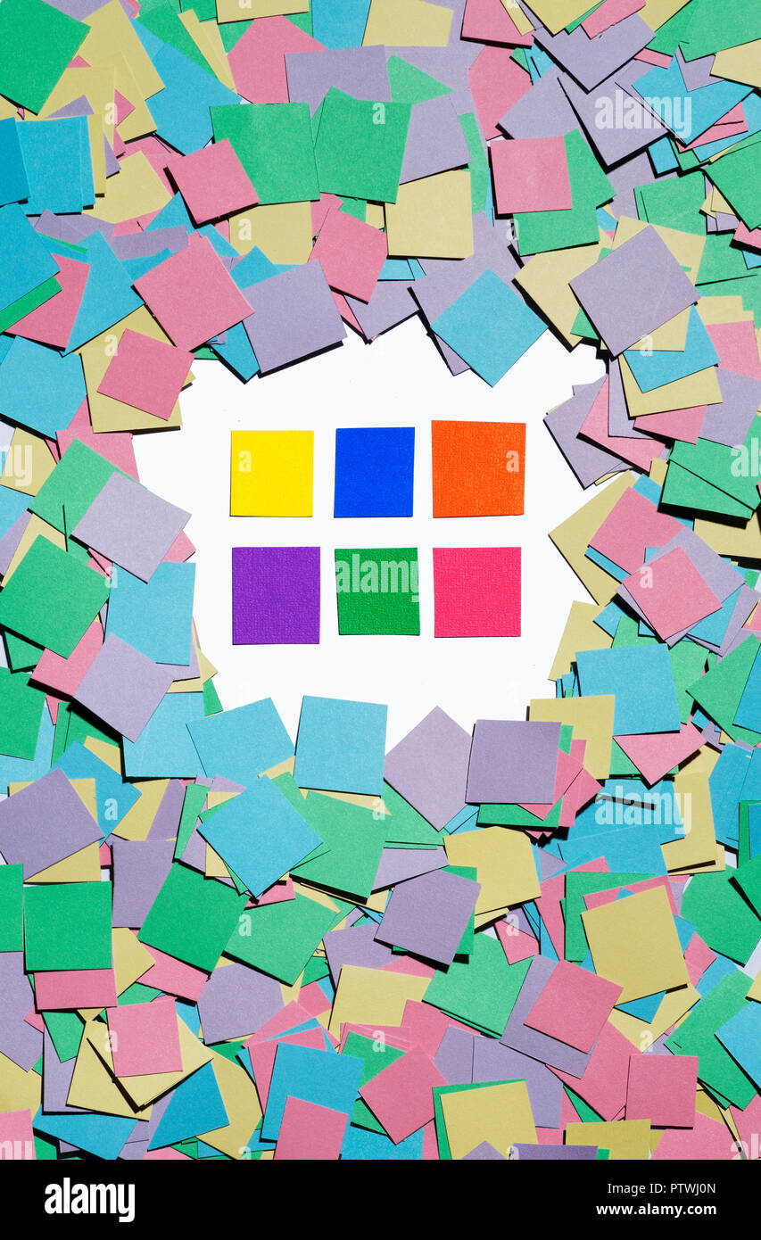 Brightly coloured sticky notes surrounded by coloured squared paper Stock Photo
