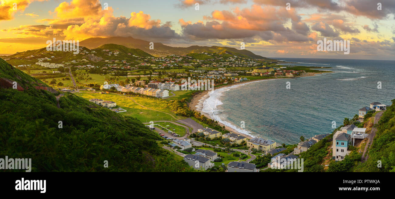 Panorama of Saint Kitts and its capital Basseterre during sunset, beautiful green mountains and a beach in paradise caribbean island with amazing gree Stock Photo