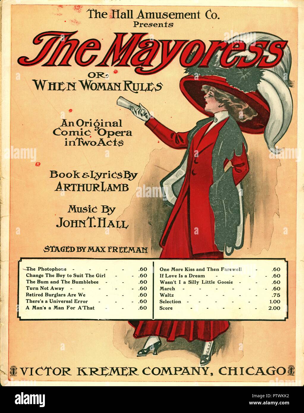 Sheet music cover for Arthur Lamb and John T Hall's 'The Mayoress,' a short, anti-suffrage, comic opera, with an illustration of a young woman, in full-length profile, wearing a red, Edwardian skirt-suit and a large red hat, published in Chicago, Illinois, for the American market by the Victor Kremer Company, 1910. () Stock Photo