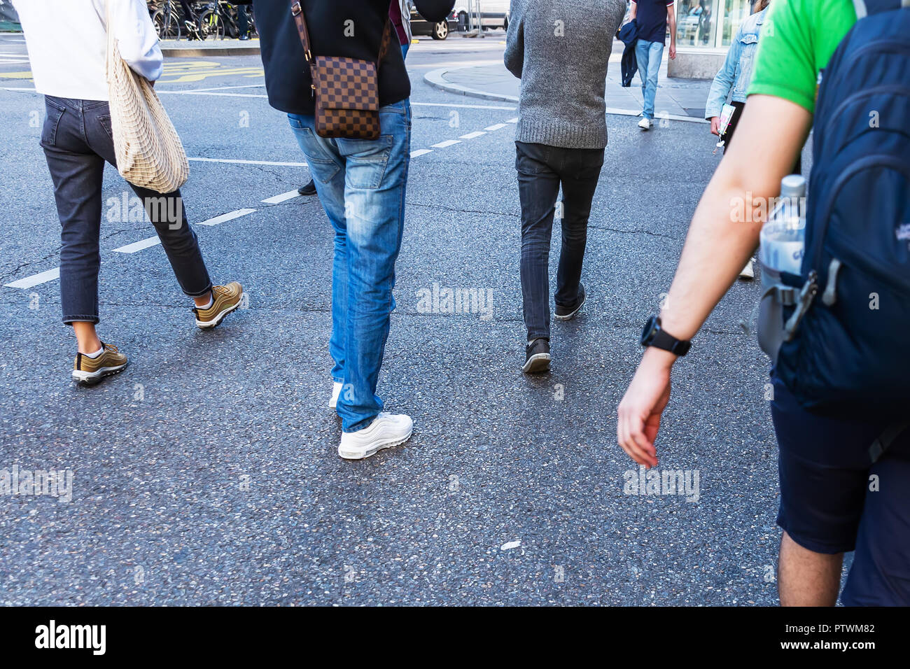 young people crossing a street in the city with camera made motion blur ...