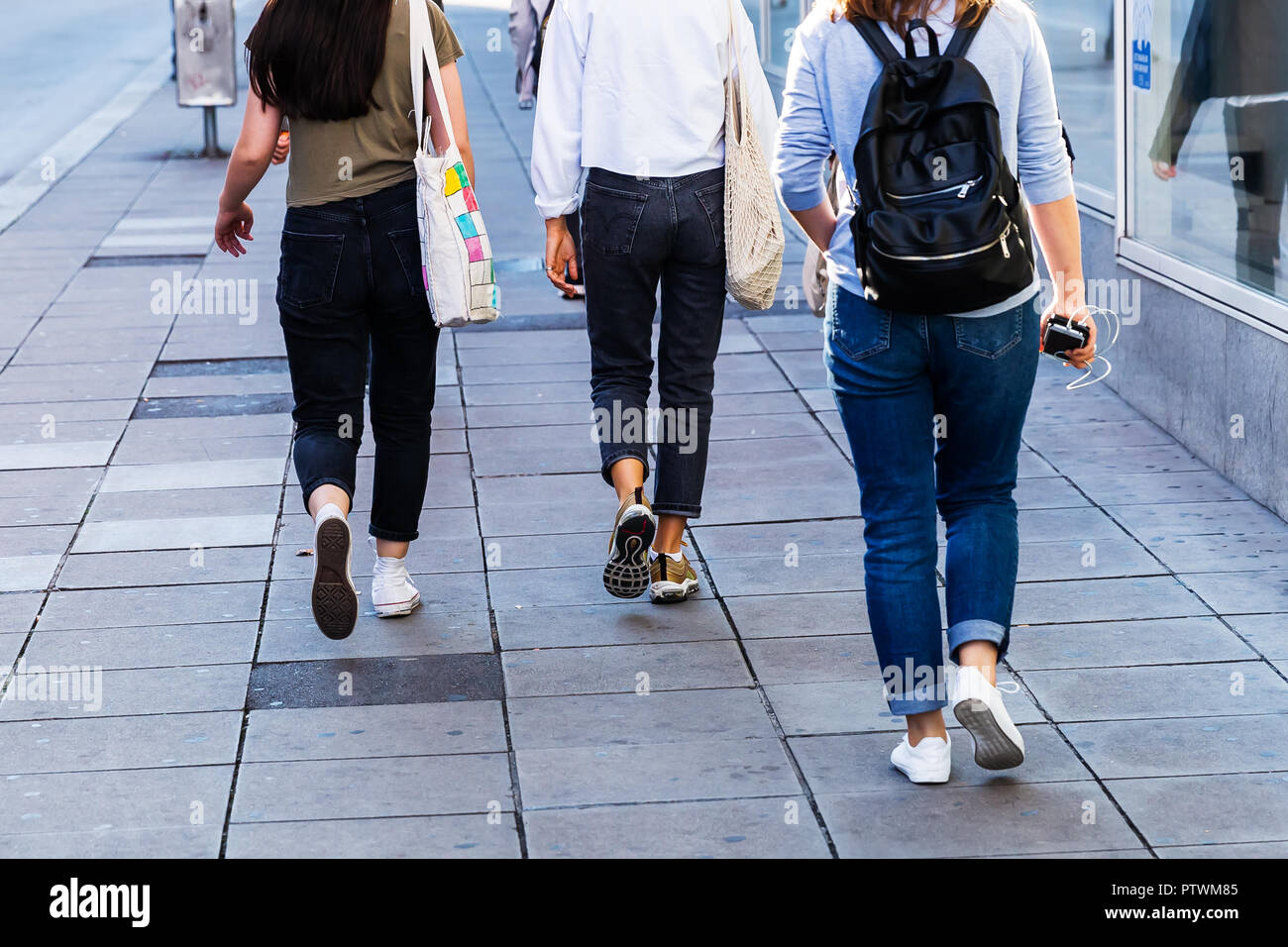 young people walking in the city with camera made motion blur effect ...
