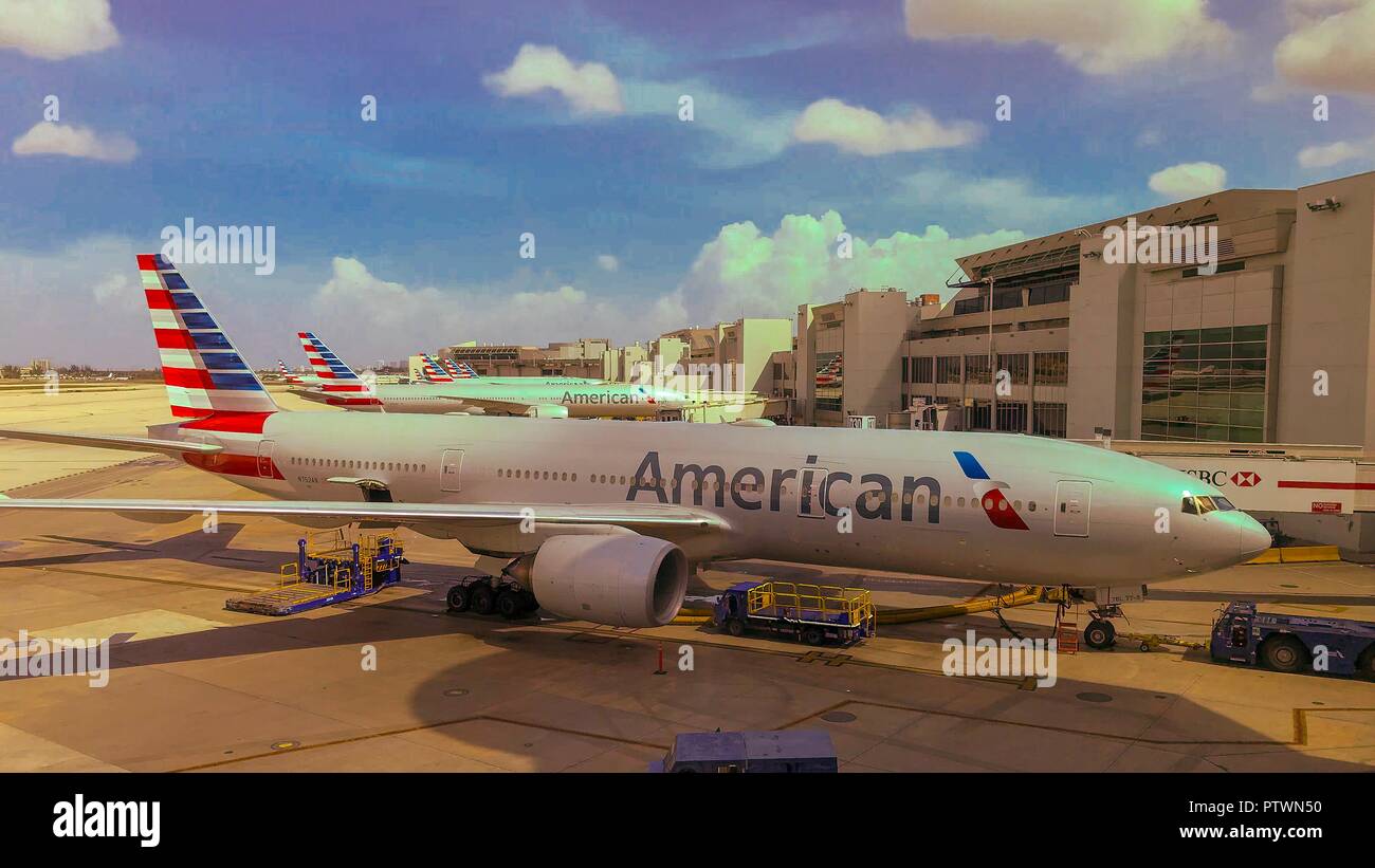 Miami, FL--Oct 2, 2018; row of American Airlines passenger planes parked at jetways at the Miami International Airport on a sunny day. Stock Photo