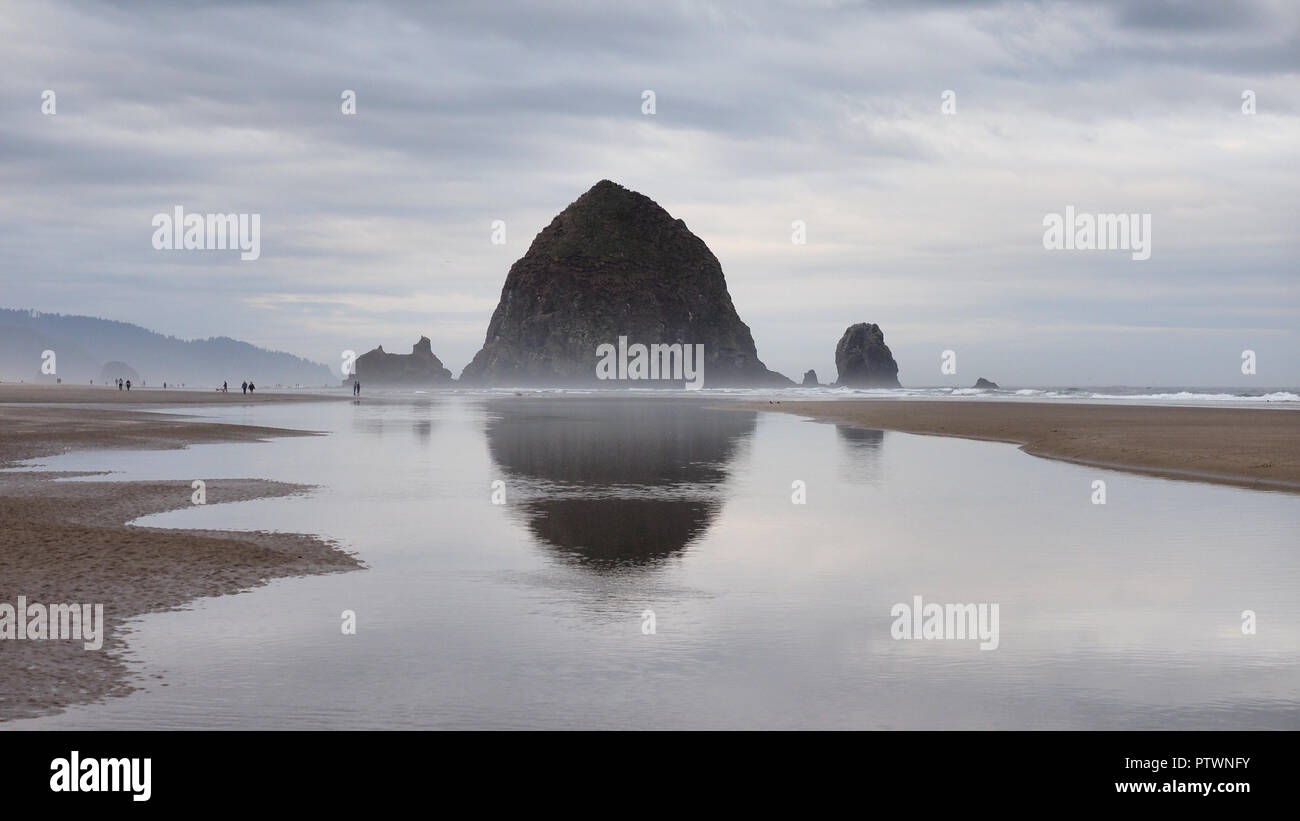 Haystack Rock reflected in the tide pools of Cannon Beach, Oregon at