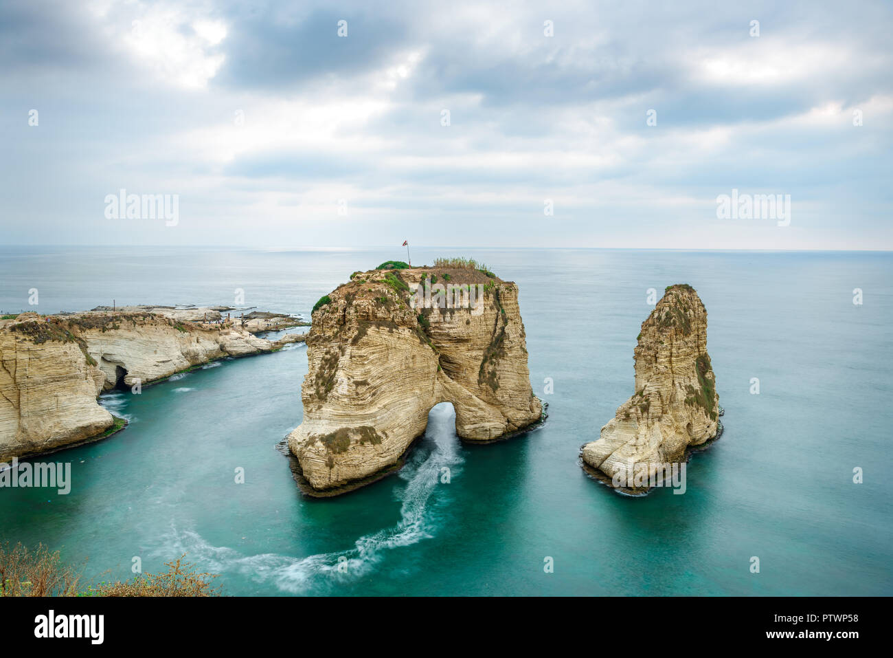 Rouche rocks in Beirut, Lebanon near sea and during sunset. Cloudy day in Beirut Lebanon Stock Photo