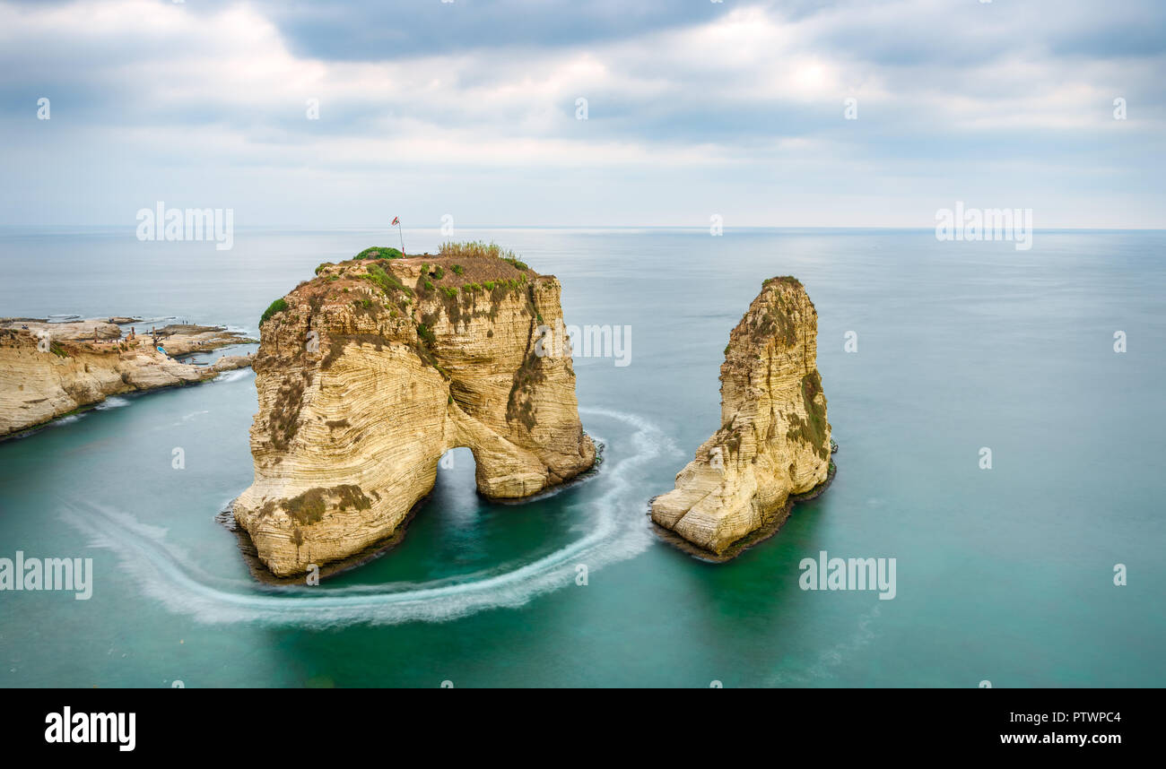Rouche rocks in Beirut, Lebanon near sea and during sunset. Cloudy day in Beirut Lebanon Stock Photo