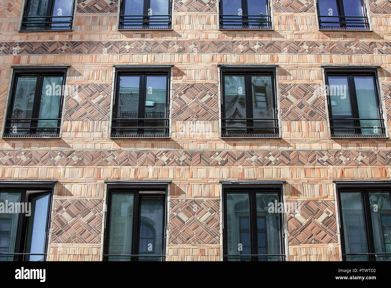 Symmetrical tiled facia of a building in Weinstrasse, Munich city centre. Stock Photo