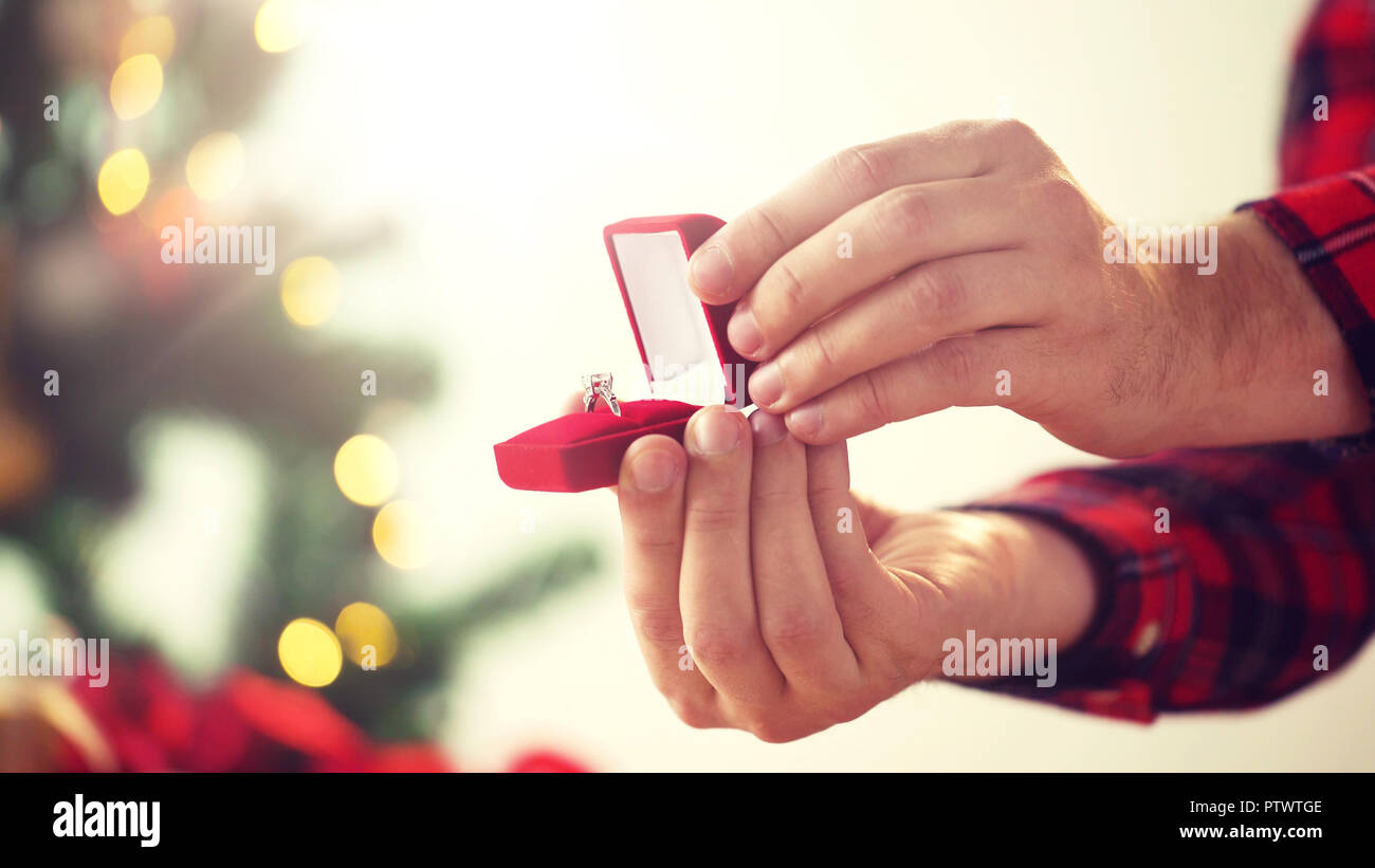 close up of hands with ring in christmas gift box Stock Photo
