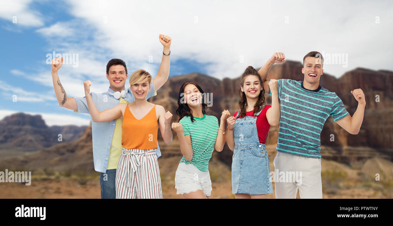 happy friends making fist pump over grand canyon Stock Photo