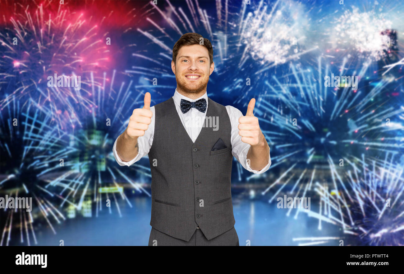 happy man showing thumbs up over firework Stock Photo