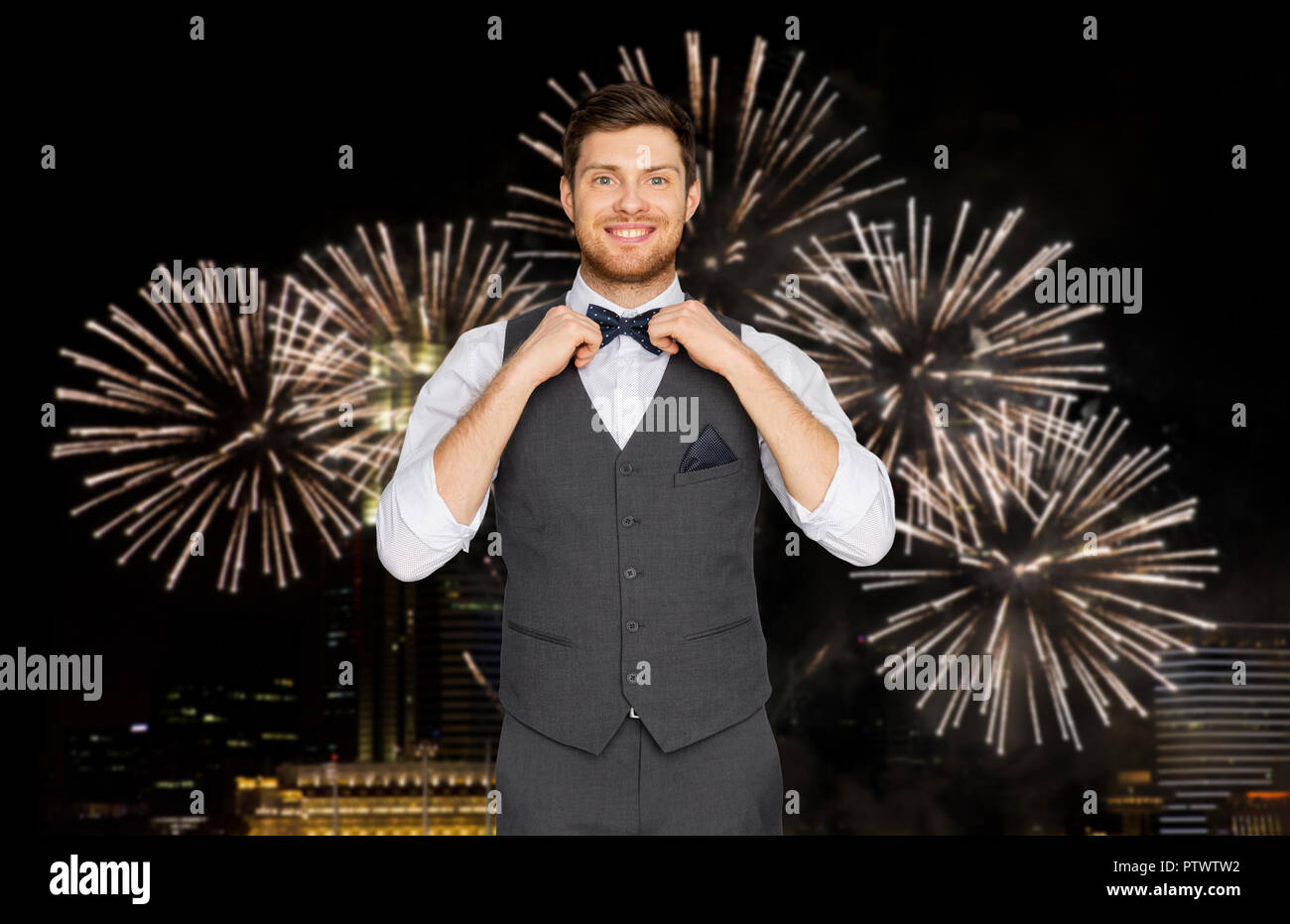 happy man in festive suit over firework in city Stock Photo