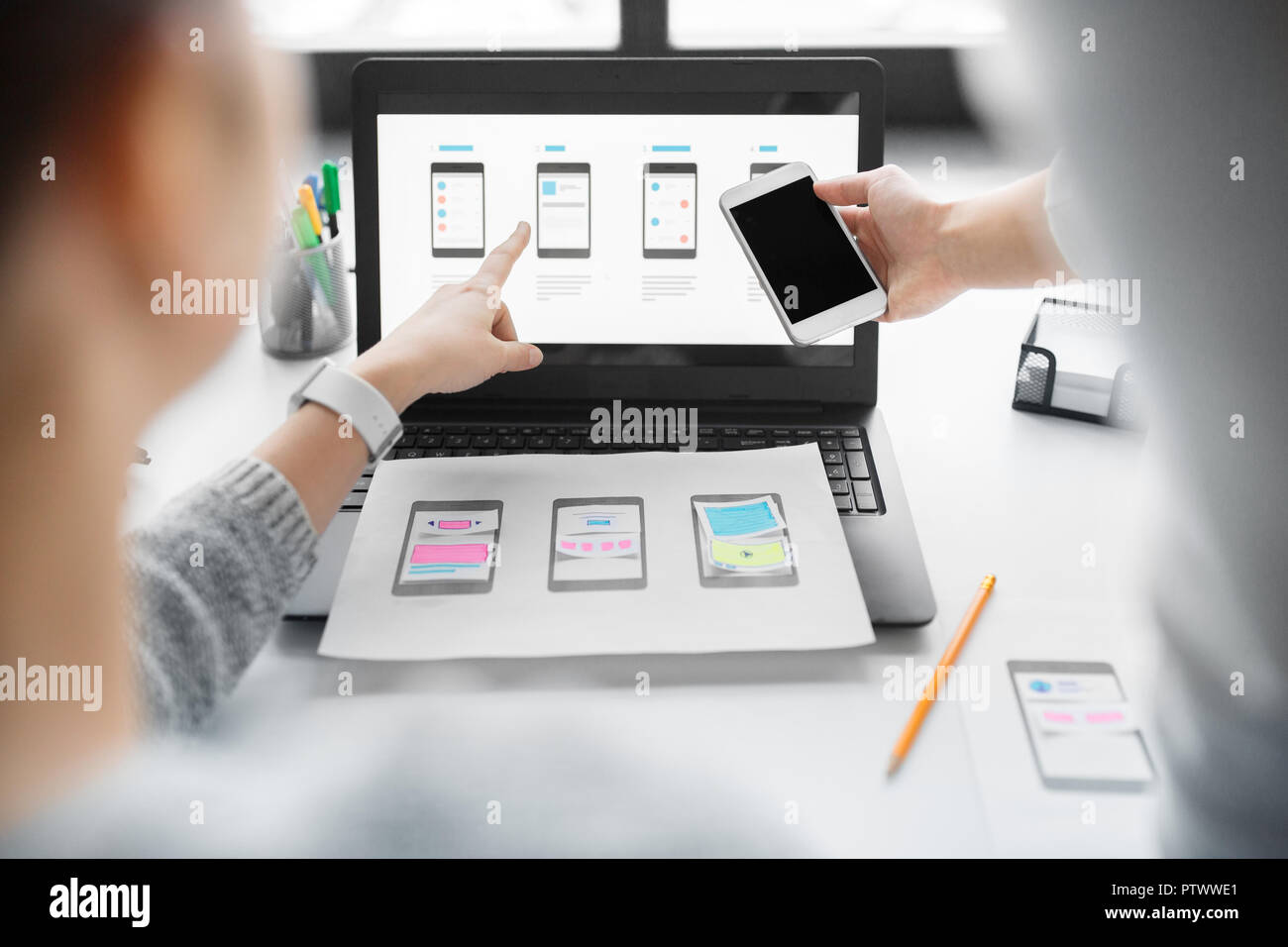 web designers work on smartphone user interface Stock Photo