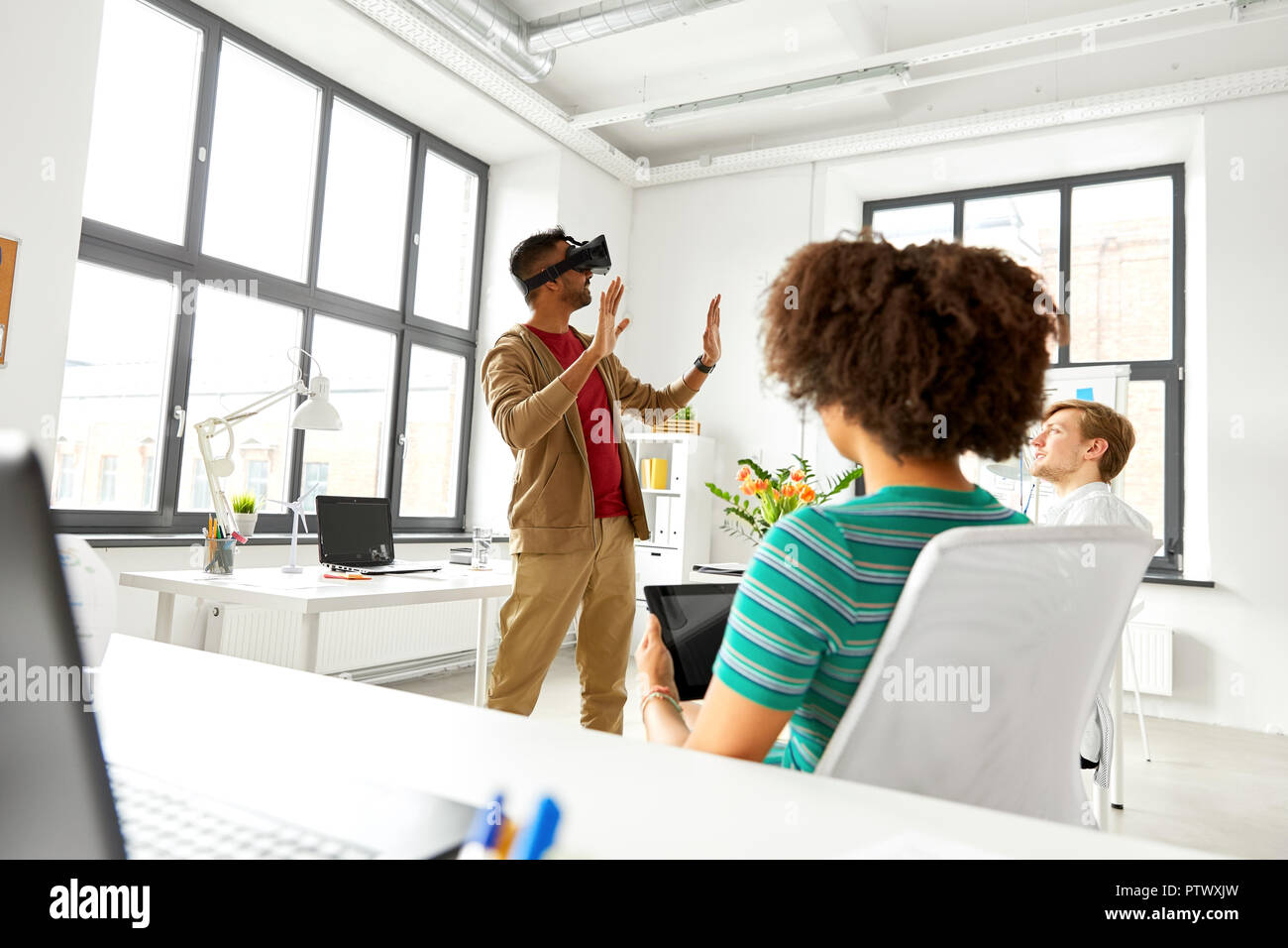 developers with virtual reality headset at office Stock Photo