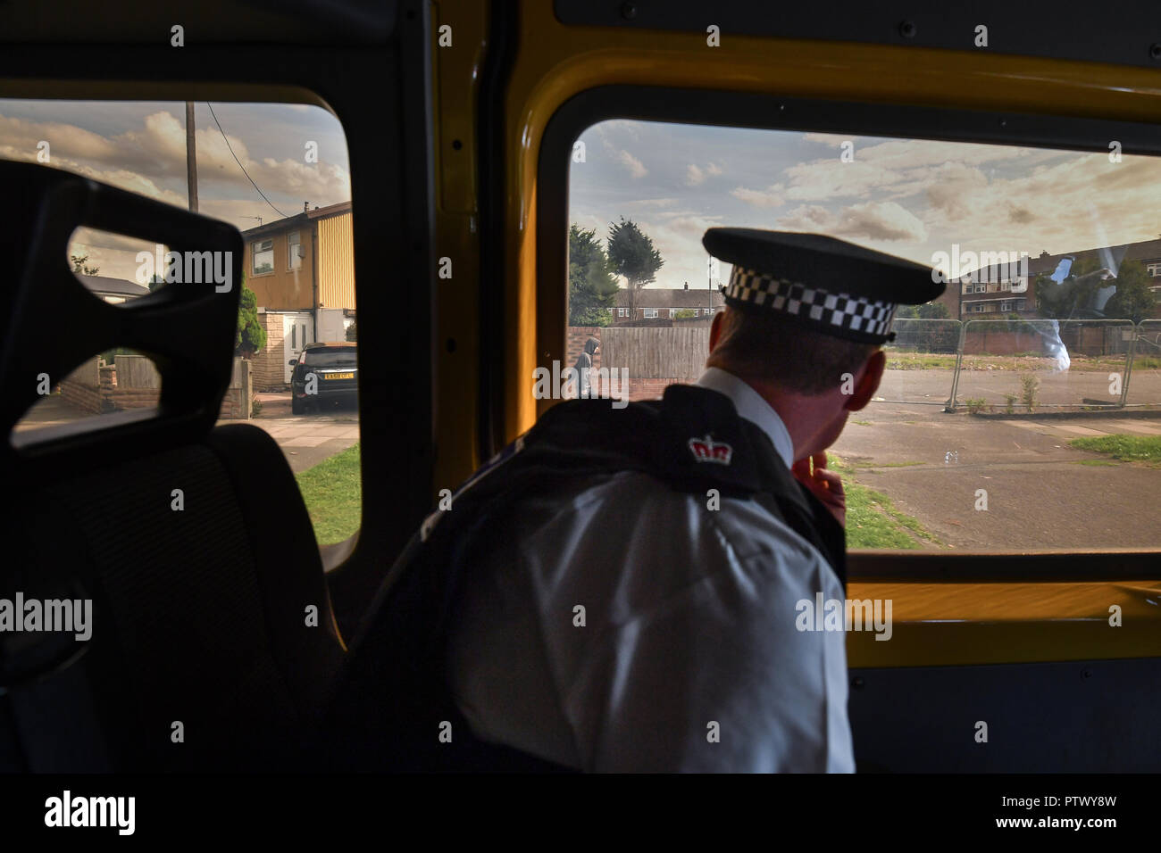 Superintendent Matt Boyle looks out of a patrol van window as Merseyside Police officers carry out a Stop and Search operation in Bootle, Liverpool Stock Photo