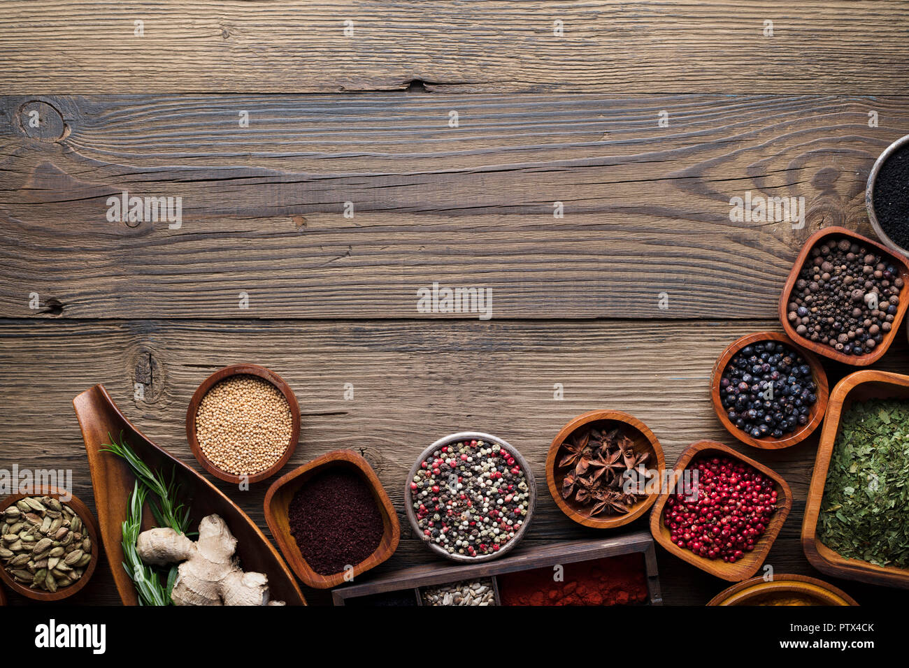 Colored spice background. Spices and herbs top view. Wooden background  Stock Photo - Alamy