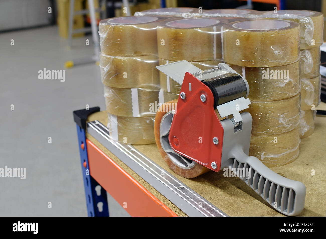 Tape dispenser and many new packing tapes in warehouse Stock Photo Alamy