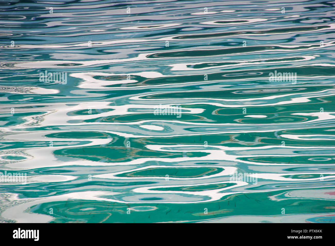 Abstract sun glare reflections on sea water surface background Stock Photo