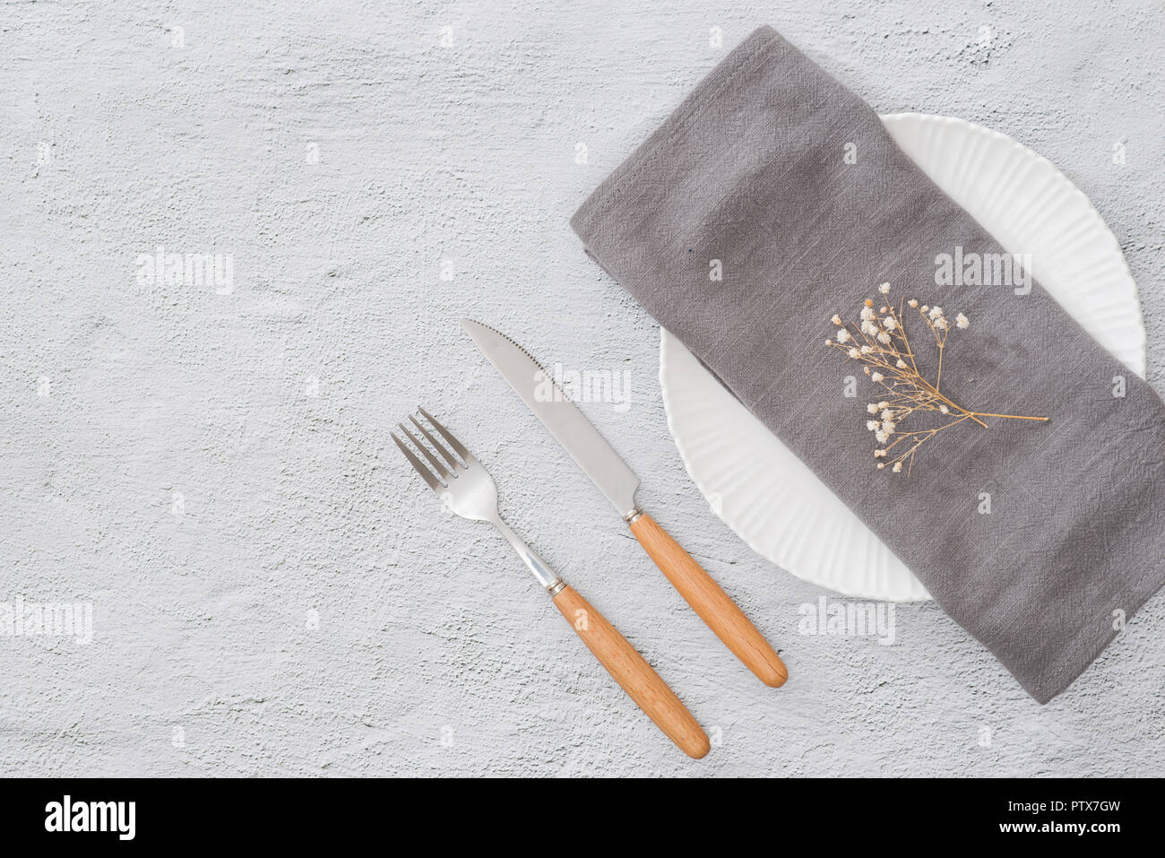 Table prepared for reservation. Arranged fork, knife and plate along