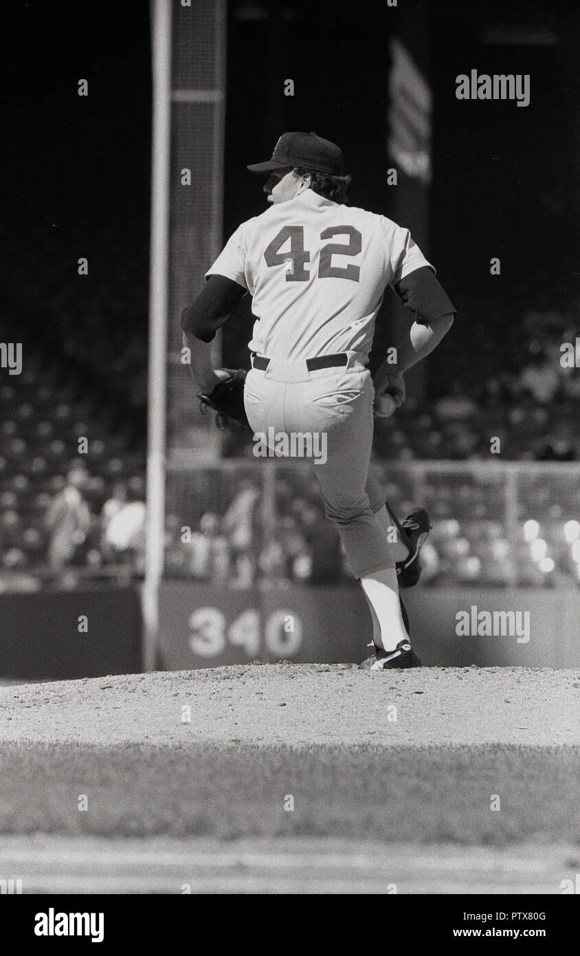 1970s, historical, USA, MLB, Major League Baseball game, photo shows a pitcher (right handed) with glove and ball and in position on his mound - a small artifical hill-  - standing on one leg about to throw (or pitch) the baseball. Stock Photo