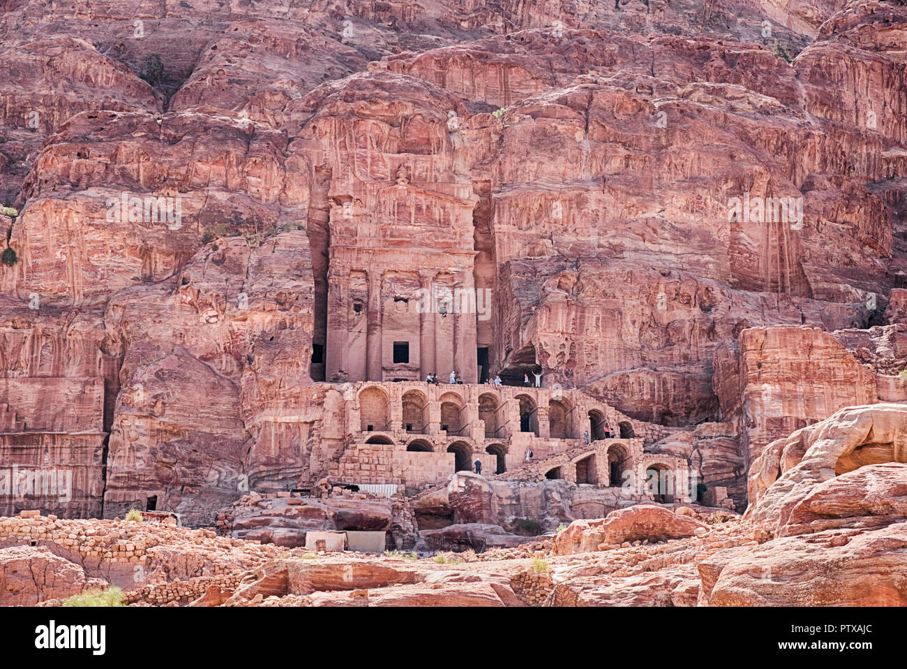 The Urn Tomb, a part of the Royal Tombs of Petra, is carved into the sandstone cliffs with a grand staircase to climb. Stock Photo