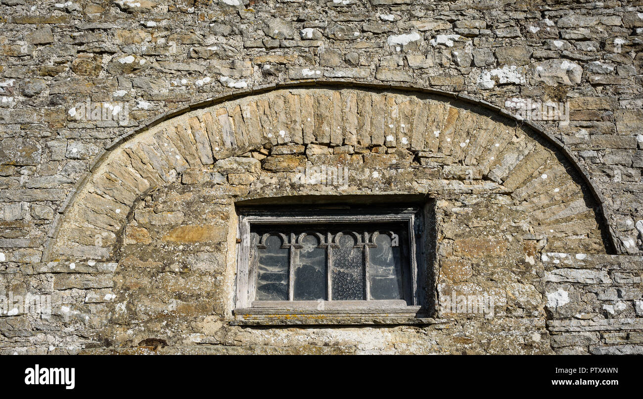 An unusual old decorative wooden framed window set in a stone barn in the Yorkshire Dales, England, Uk. Stock Photo