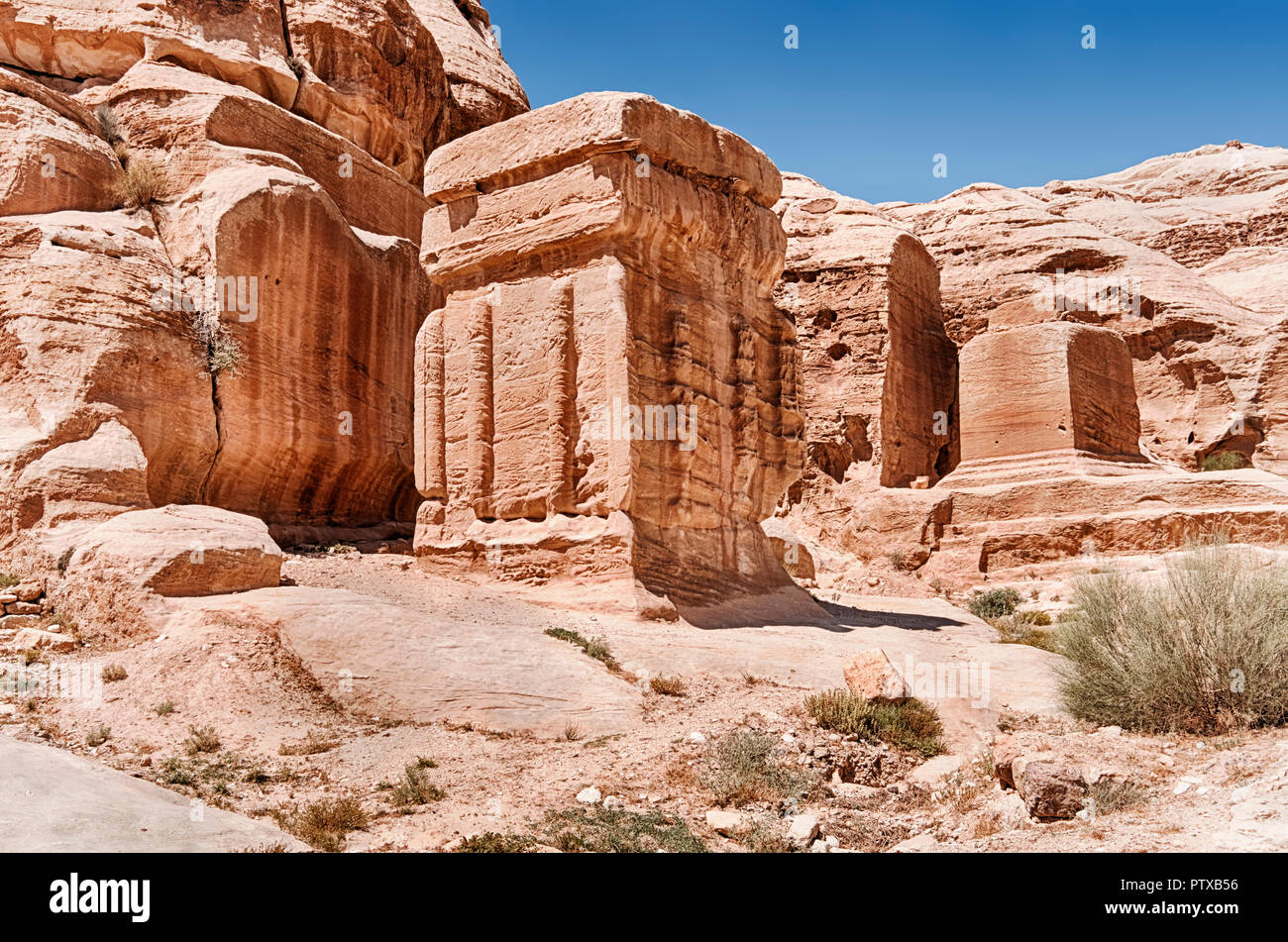 The God Blocks, or Djinn Blocks, are some of the first stone carvings seen after the entrance of Petra in Jordan. Stock Photo