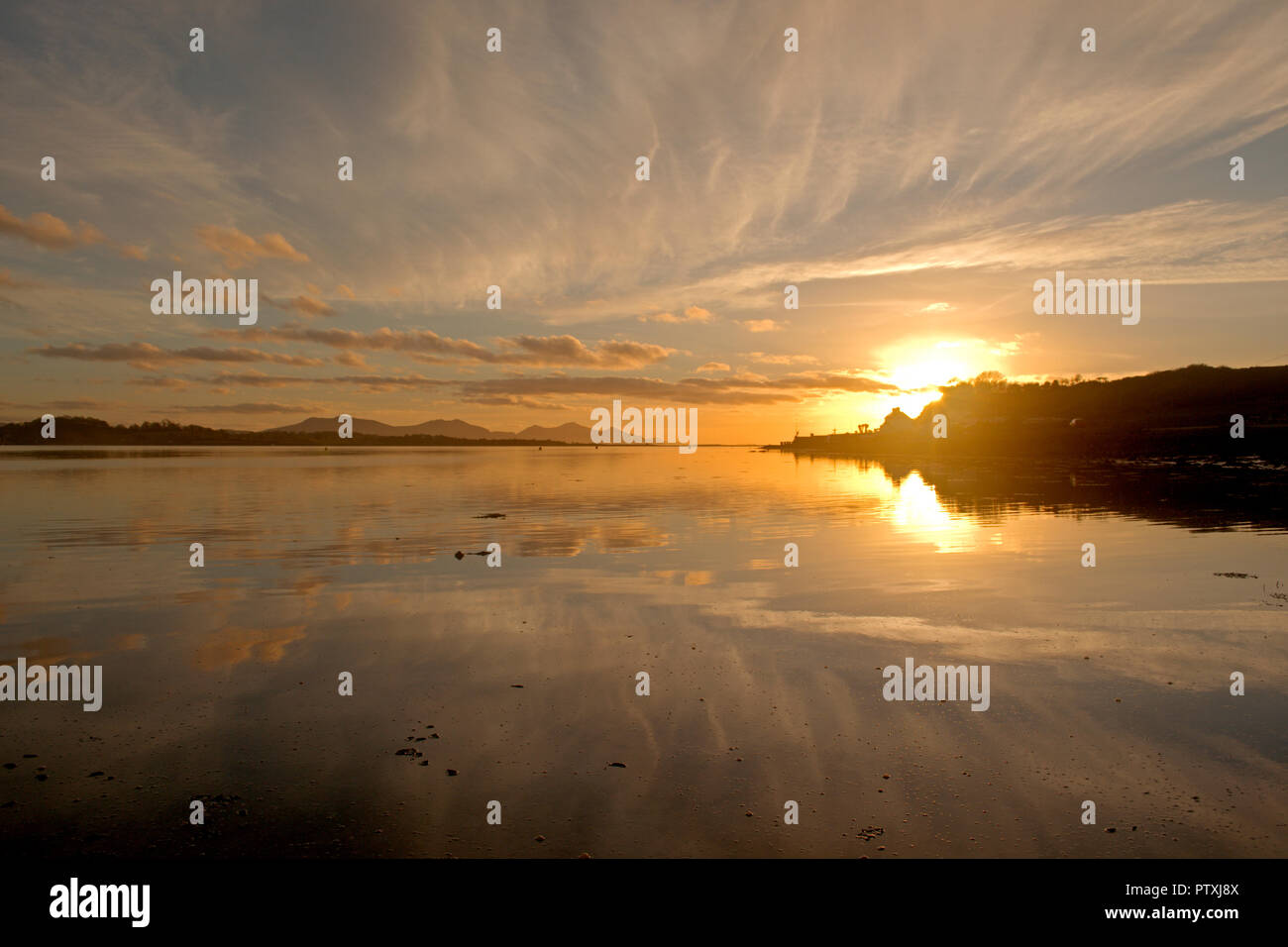 Sunset over the Menai Straits, North Wales, with reflections Stock Photo