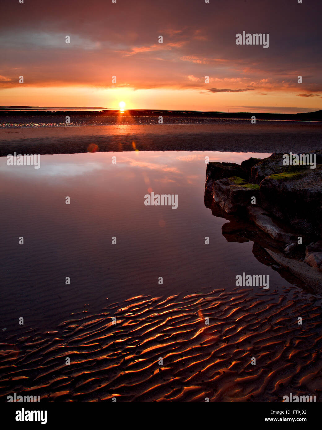 Sunset over the West Shore beach at Llandudno on the North Wales coast Stock Photo