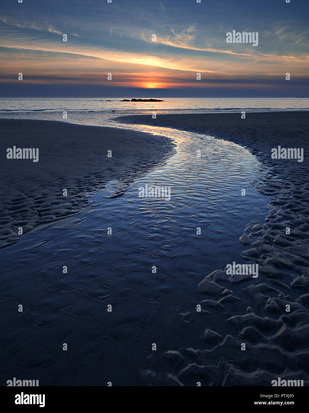 Sunset over the Anglesey coast at Porth Trwyn Stock Photo