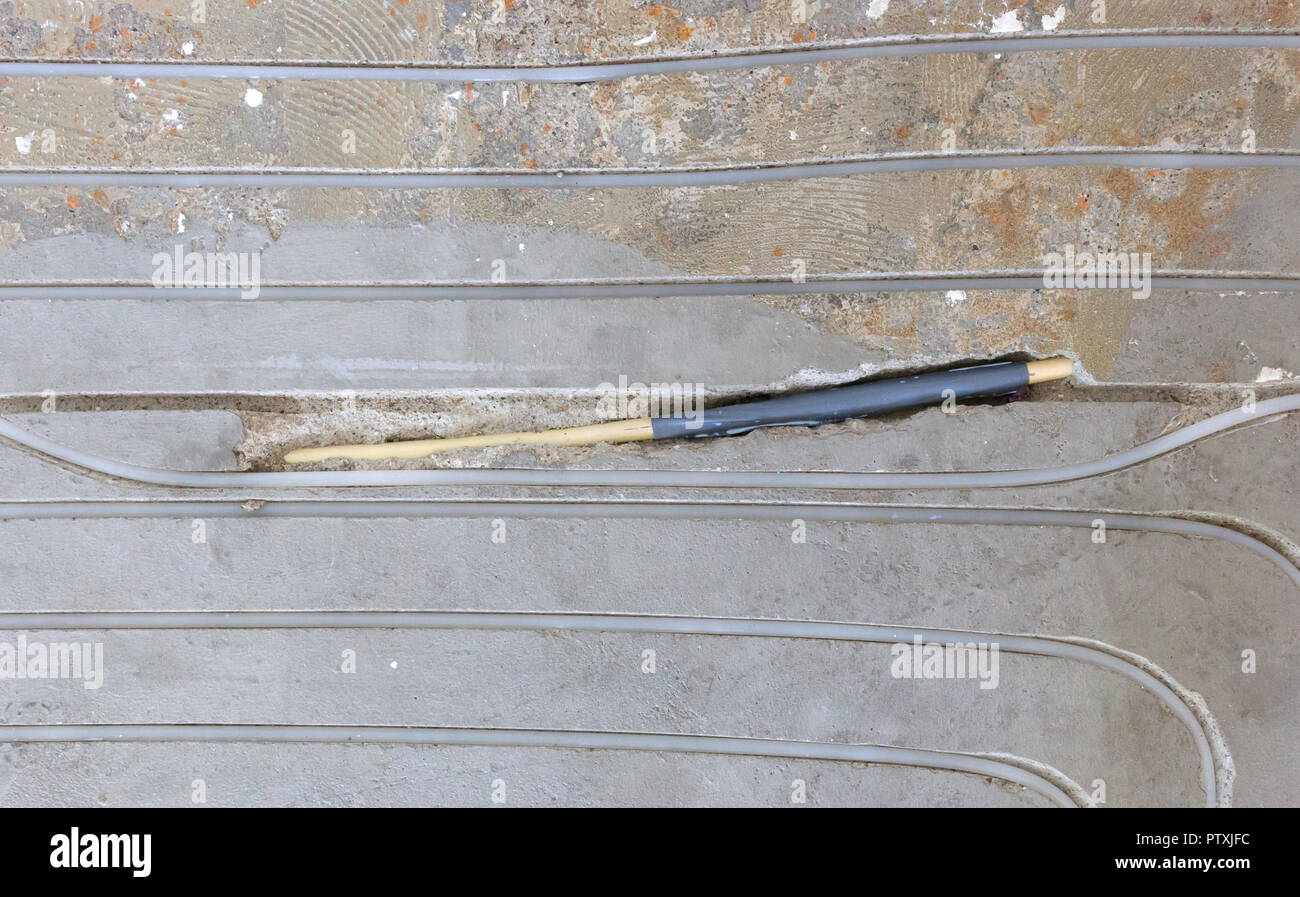 Broken wire in the floor, installing underfloor heating Stock Photo Alamy